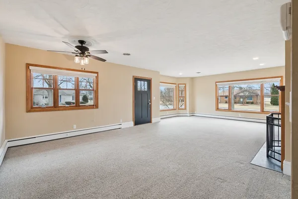 wooden floor chandelier and windows in an empty room