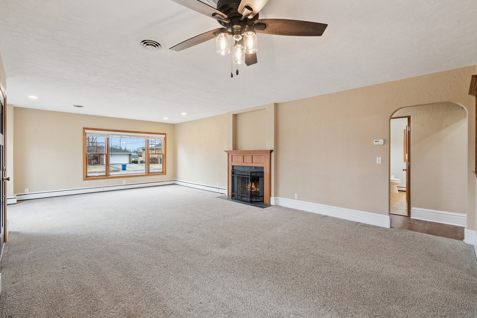 1416 6th Street Orion, IL 61273 - Photo 7 of 48 a view of an empty room with chandelier fan and fire place