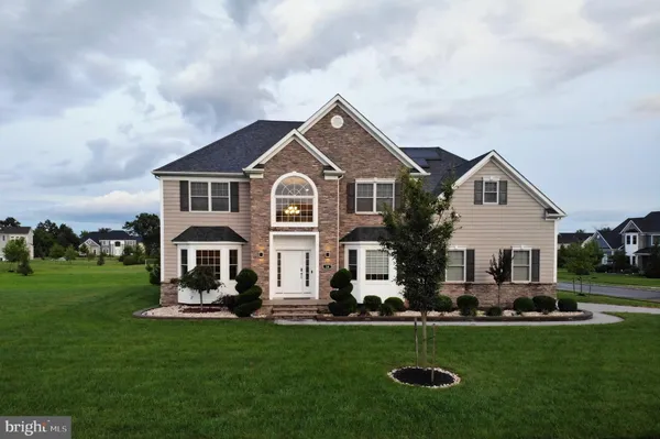 a front view of house with yard and green space