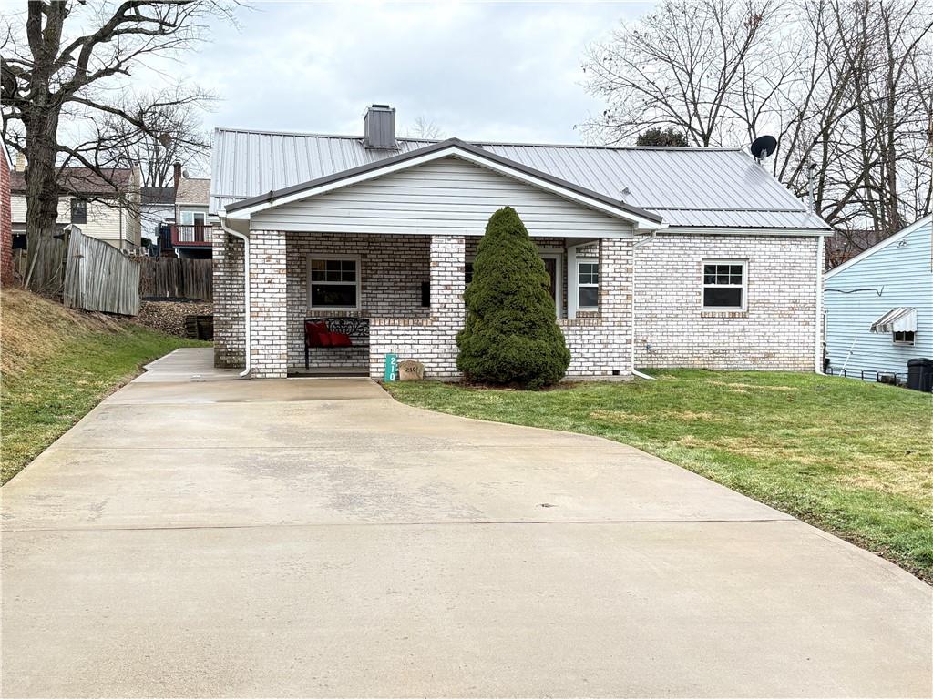 FRONT OF HOUSE WITH CONCRETE DRIVE WAY