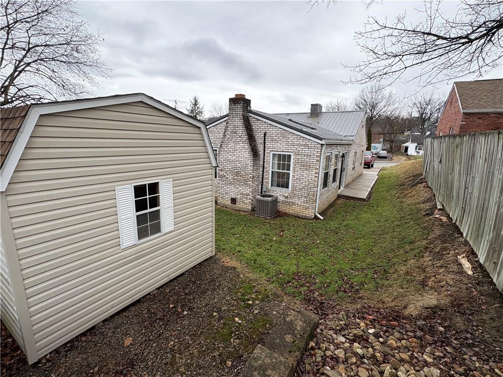 210 Carson Street Springdale, PA 15144 - Photo 32 of 33 SIDE OF HOUSE WITH CONCRETE WALK WAY TO FAMILY ROOM