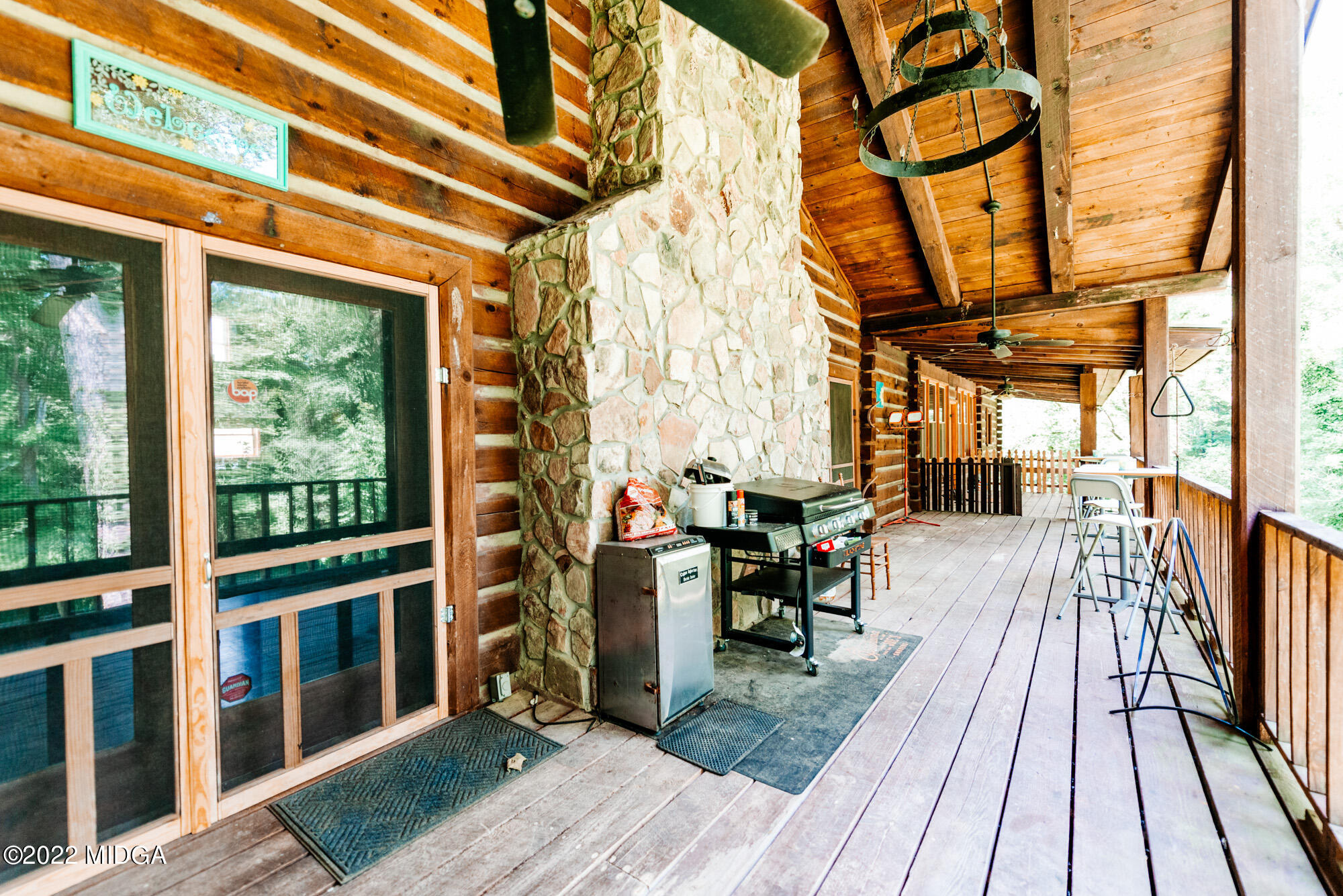 7426 Thomaston Road Macon, GA 31220 - Photo 30 of 42 a view of a porch with wooden floor and outdoor seating