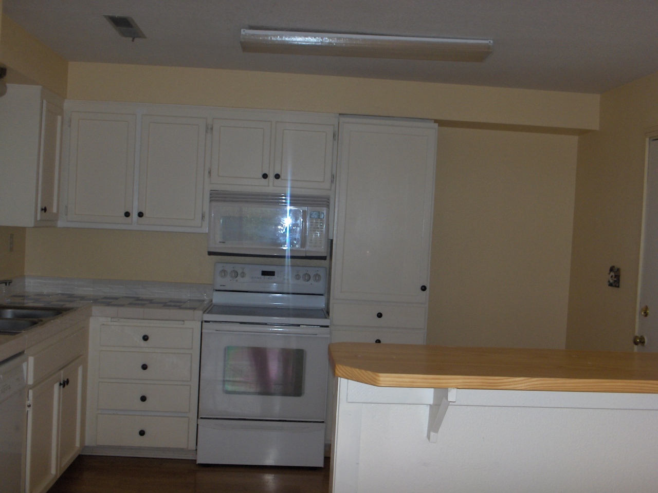 1194 Echo Road Redding, CA 96002 - Photo 13 of 17 a kitchen with granite countertop white cabinets and white appliances