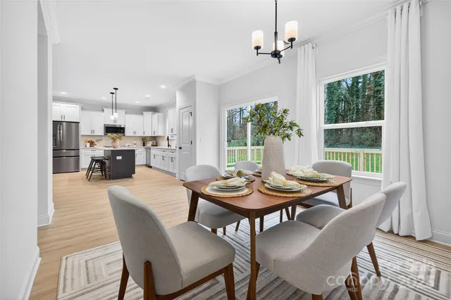a dining room with furniture a livingroom and chandelier
