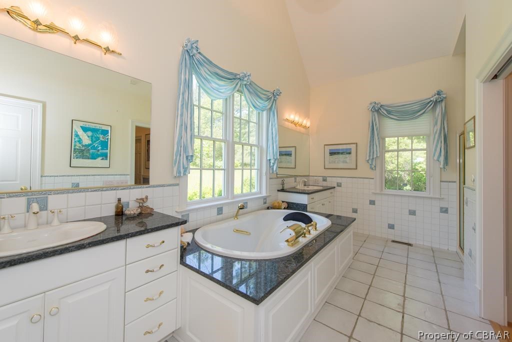 1193 West Point Road Lancaster, VA 22503 - Photo 36 of 50 a bathroom with a tub sink and mirror