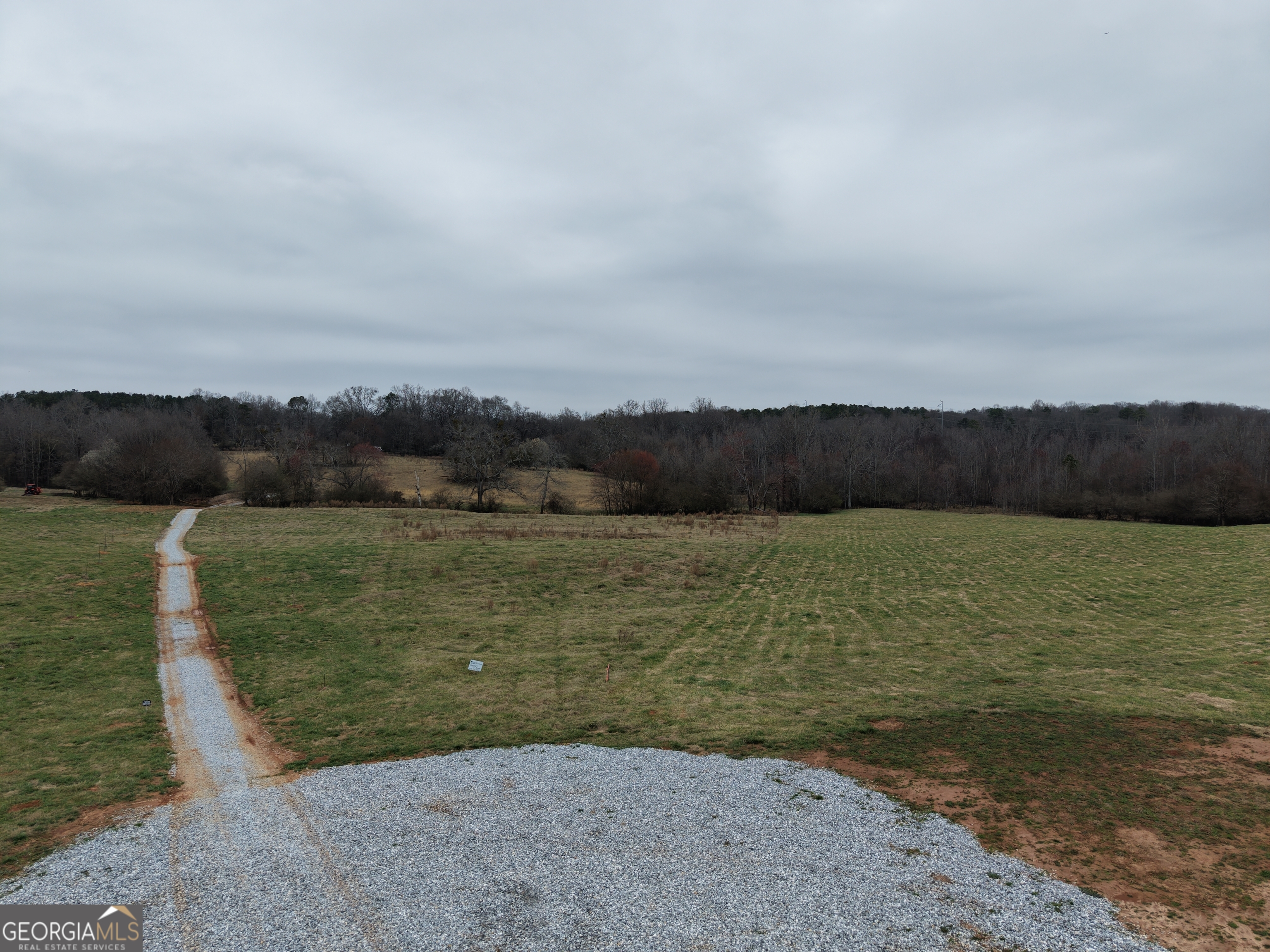 9 Red Rose Court Nicholson, GA 30565 - Photo 35 of 55 a view of a lake with houses in the back