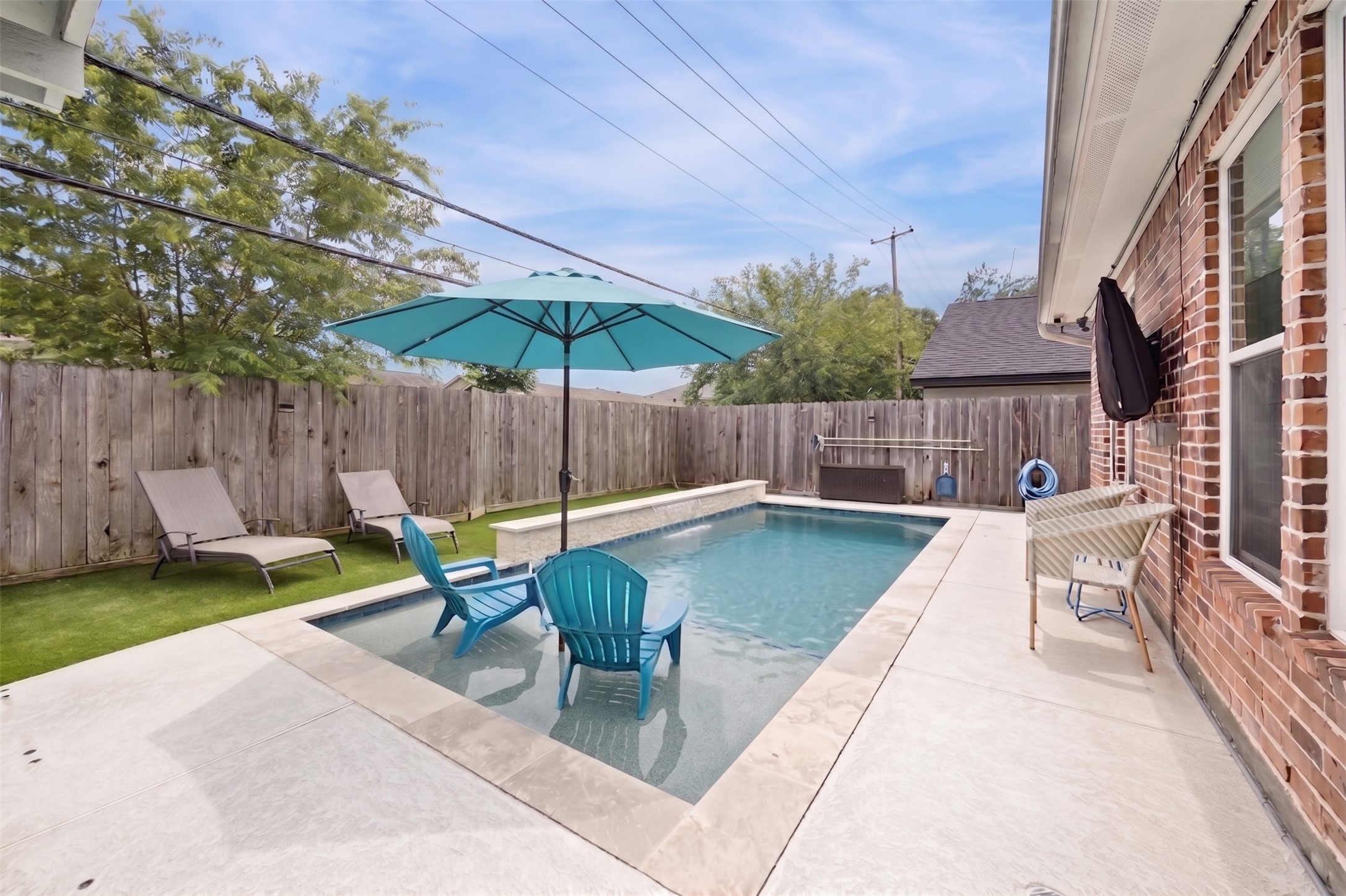 5121 Libbey Drive Houston, TX 77092 - Photo 24 of 24 Dive into your own private oasis with a sparkling pool highlighted by elegant waterfall feature. It’s the perfect backyard retreat for relaxing and staying cool throughout the seasons. Don't miss this special home!