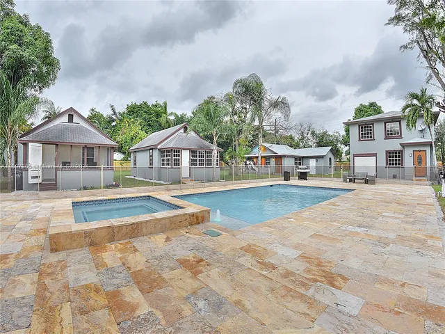 a house with swimming pool in front of it
