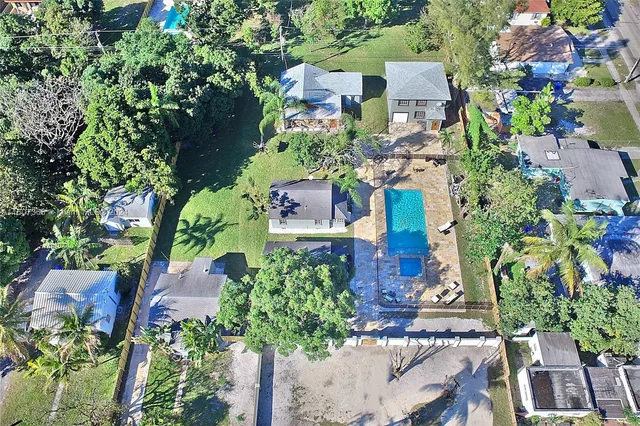 an aerial view of a house with a yard