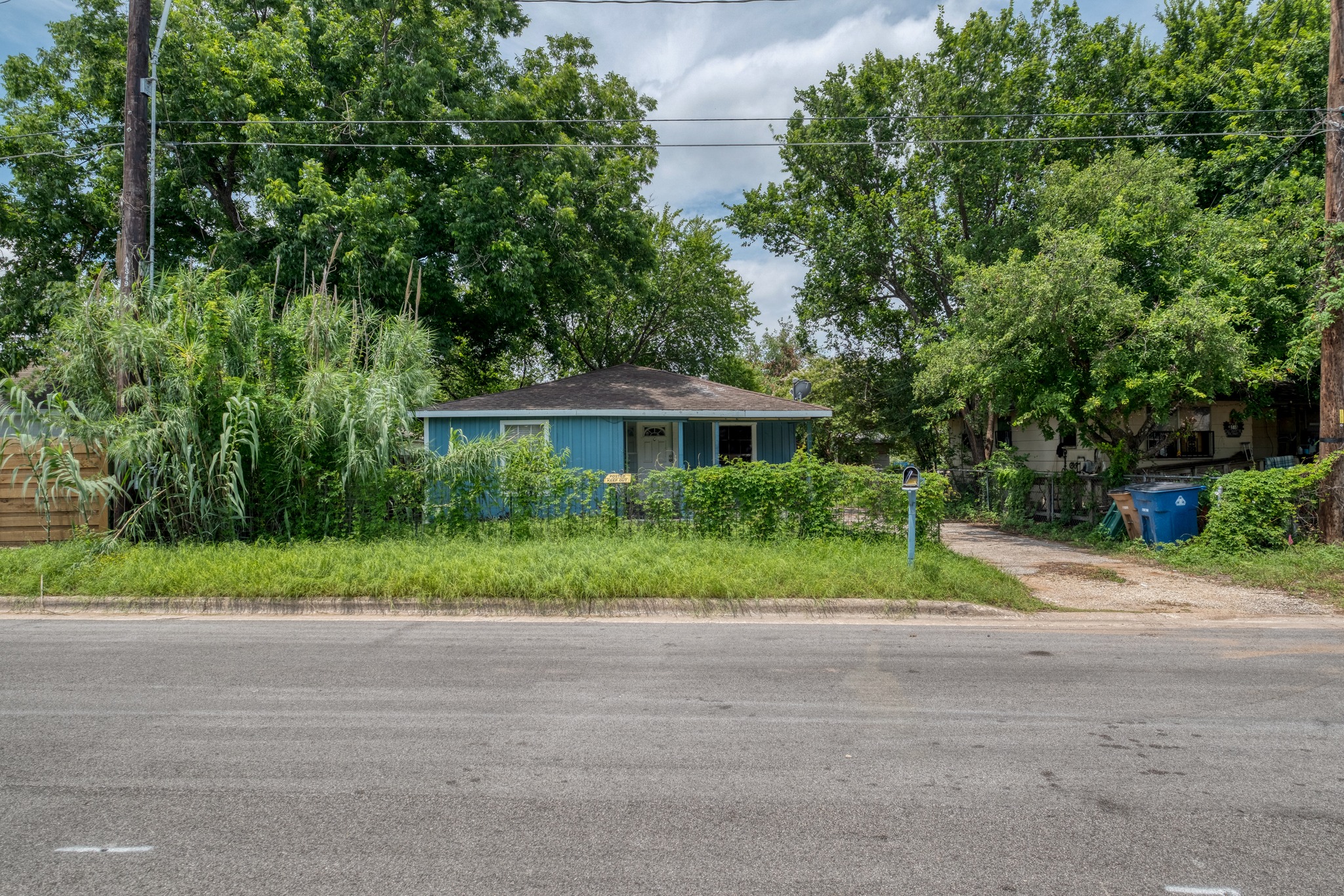 6409 Del Monte Road Austin, TX 78741 - Photo 2 of 15 A charming, single-story residence with mature trees and a quaint front yard offers peaceful living.