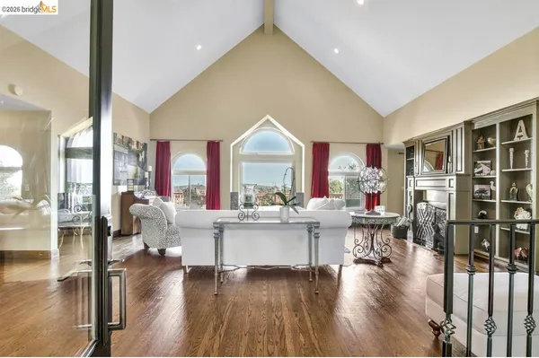 a living room with furniture a wooden floor and a large window