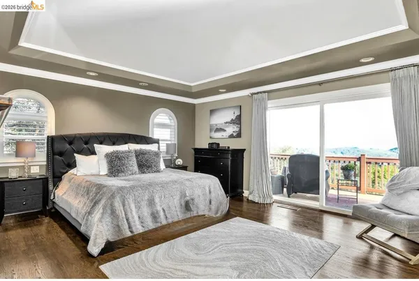 a bedroom with a large bed and a flat tv screen