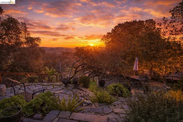 an aerial view of a house with a yard and street