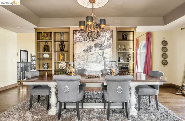 a view of a dining room with furniture wooden floor and chandelier