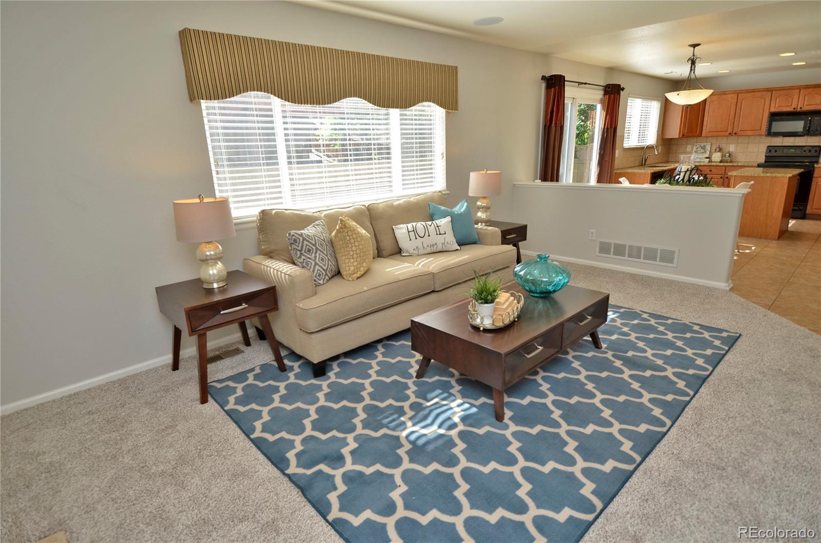 10699 Wynspire Way Highlands Ranch, CO 80130 - Photo 11 of 40 a living room with furniture and a window