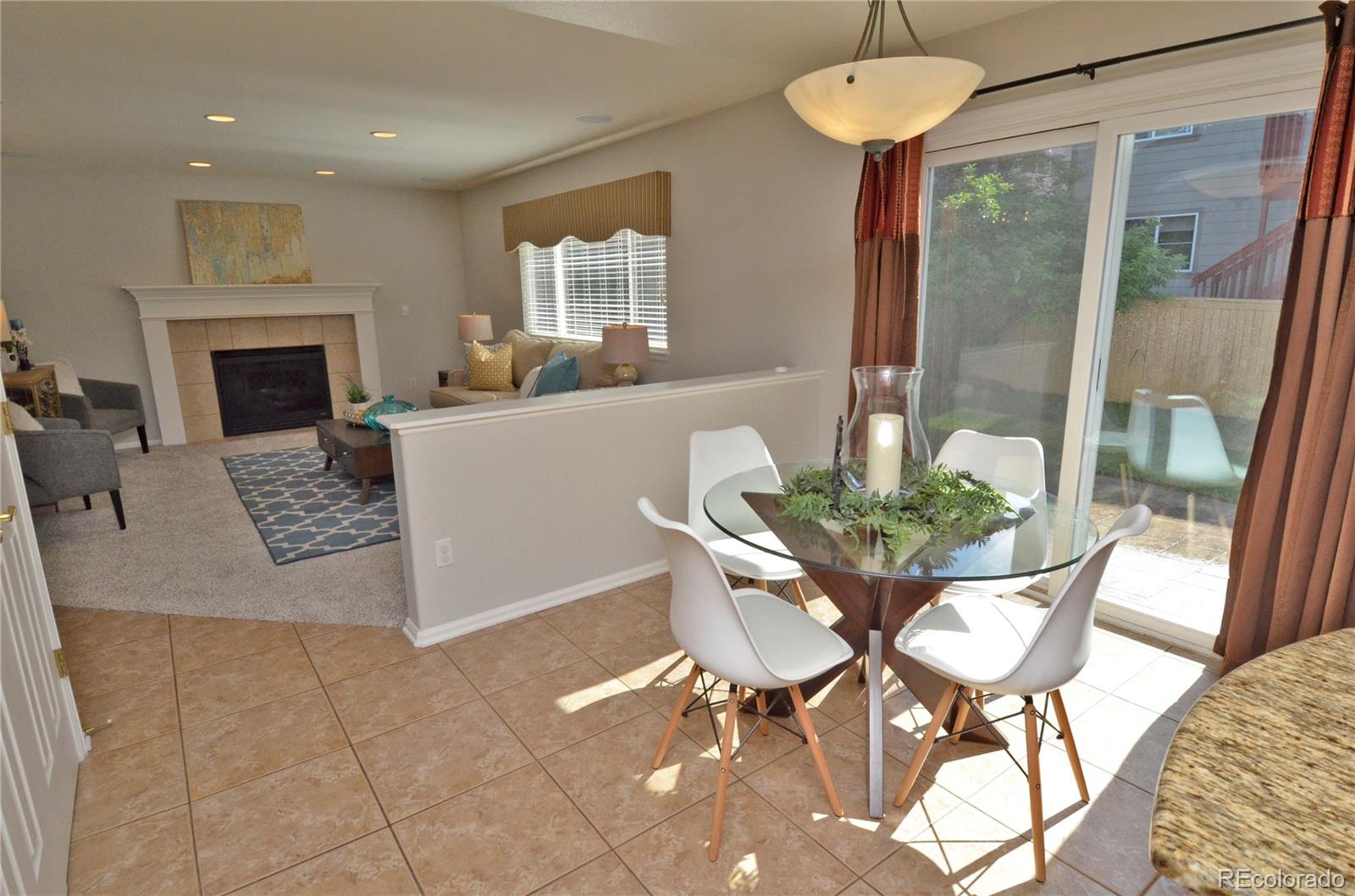 10699 Wynspire Way Highlands Ranch, CO 80130 - Photo 15 of 40 a living room with furniture a window and a fireplace