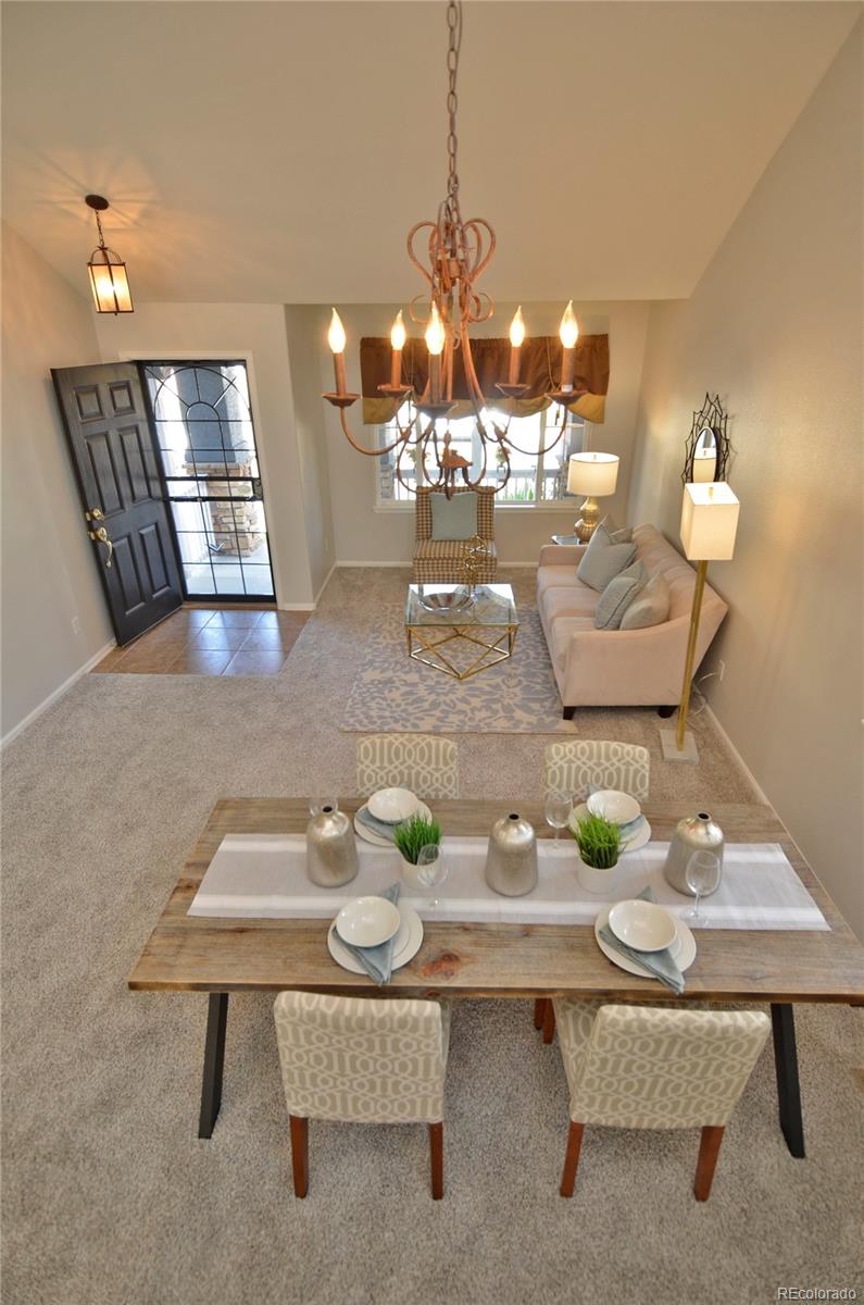 10699 Wynspire Way Highlands Ranch, CO 80130 - Photo 20 of 40 a view of a dining room with furniture and chandelier