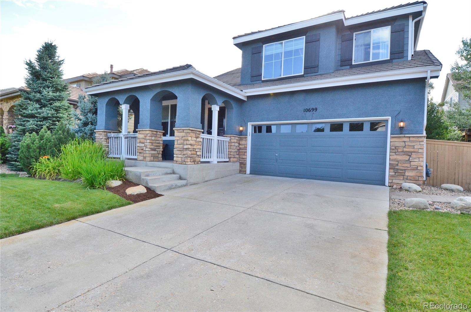 10699 Wynspire Way Highlands Ranch, CO 80130 - Photo 2 of 40 a front view of a house with garden