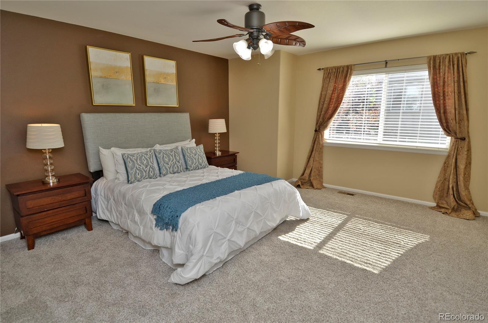 10699 Wynspire Way Highlands Ranch, CO 80130 - Photo 24 of 40 a bedroom with a bed and a window