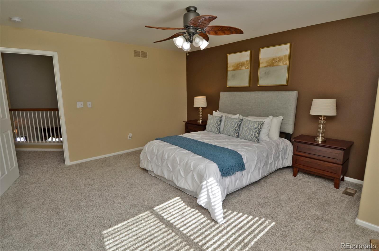 10699 Wynspire Way Highlands Ranch, CO 80130 - Photo 25 of 40 a bedroom with a bed and a chandelier