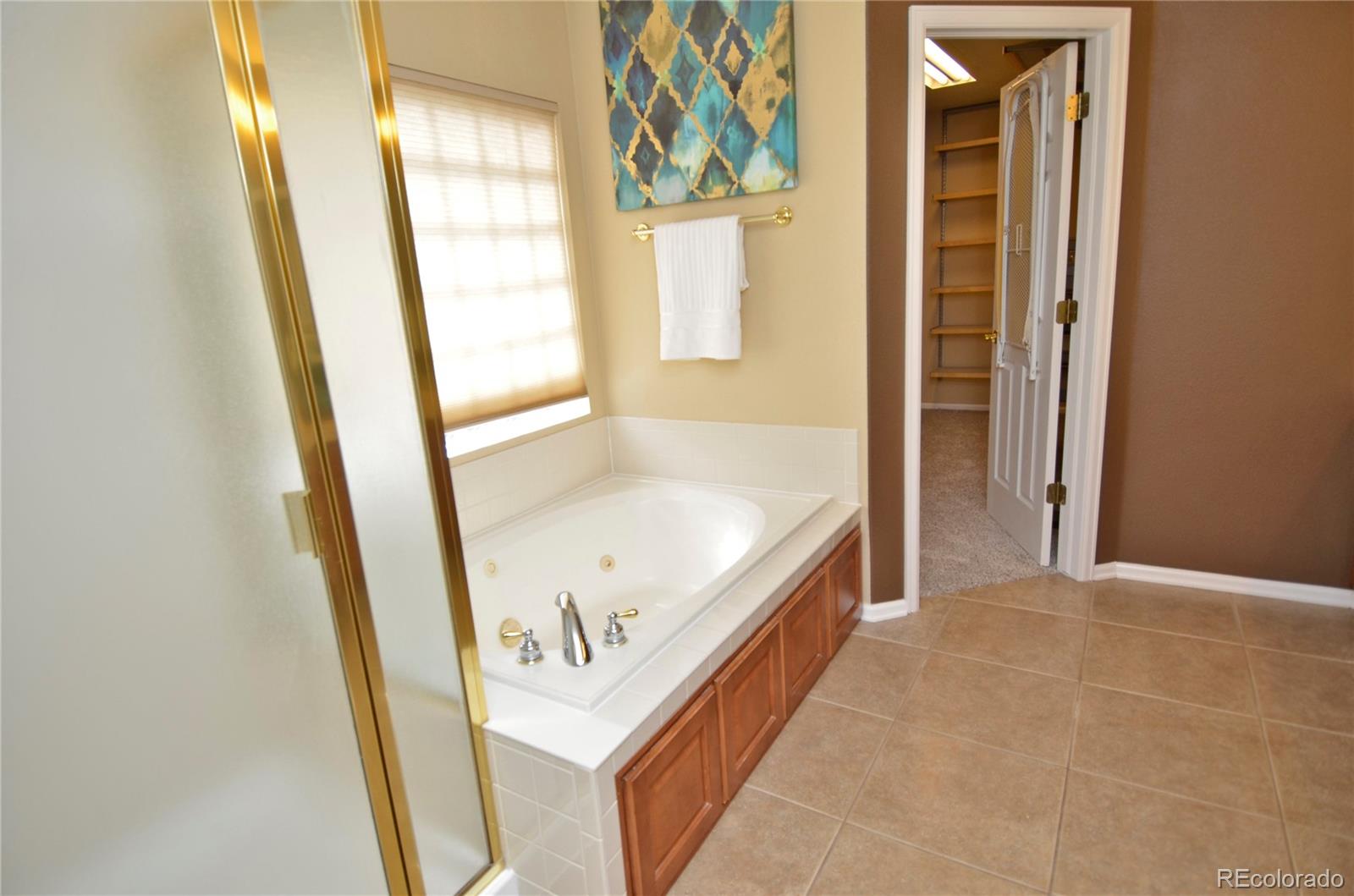 10699 Wynspire Way Highlands Ranch, CO 80130 - Photo 26 of 40 a bathroom with a tub and a window