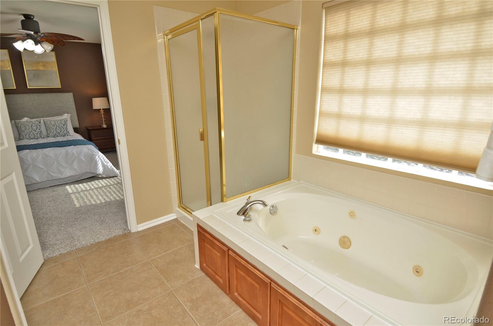 10699 Wynspire Way Highlands Ranch, CO 80130 - Photo 27 of 40 a bathroom with a tub and shower