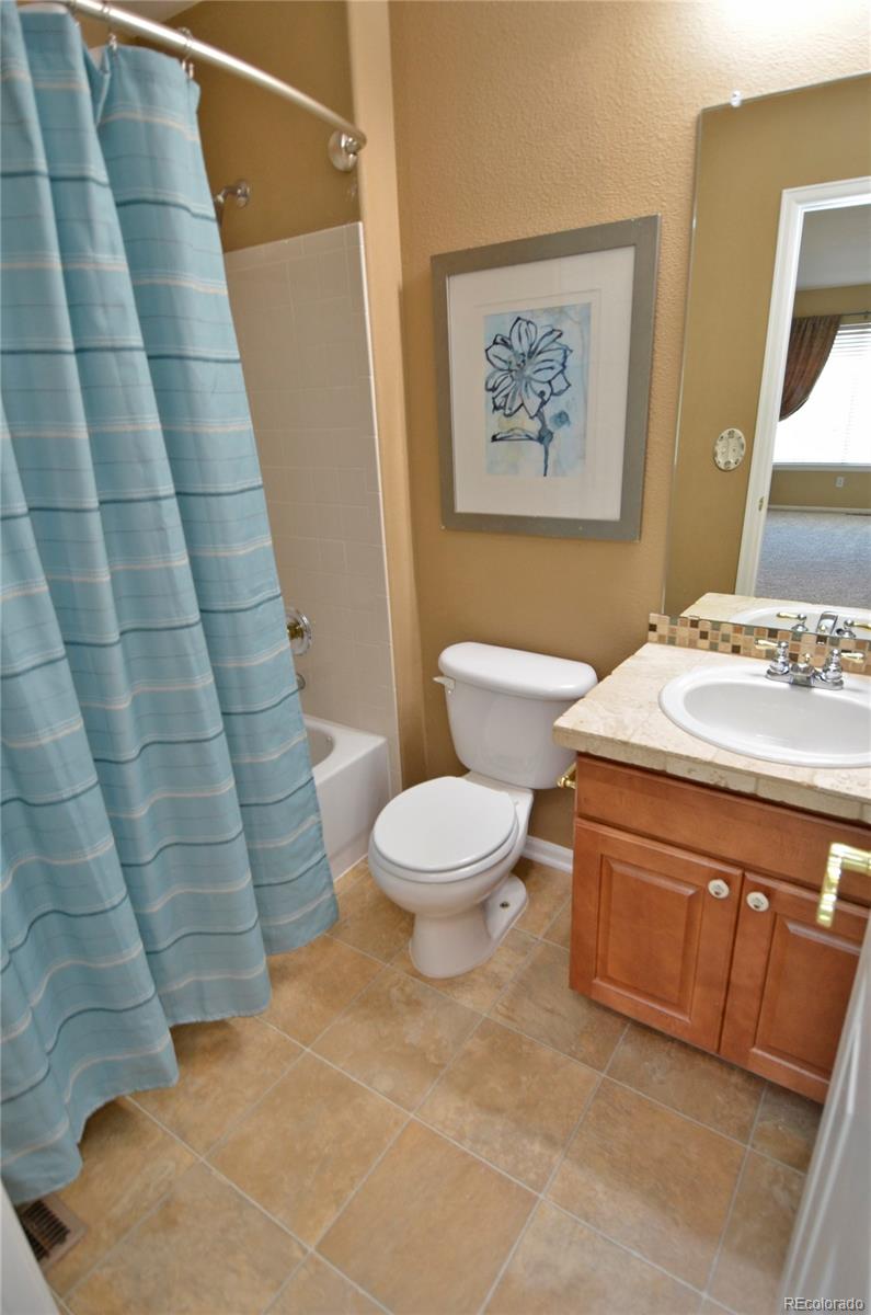 10699 Wynspire Way Highlands Ranch, CO 80130 - Photo 32 of 40 a bathroom with a sink a toilet and shower