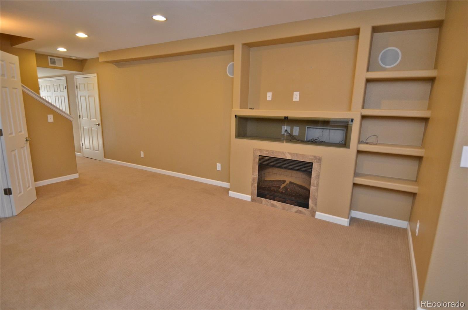 10699 Wynspire Way Highlands Ranch, CO 80130 - Photo 35 of 40 a view of an empty room with a fireplace