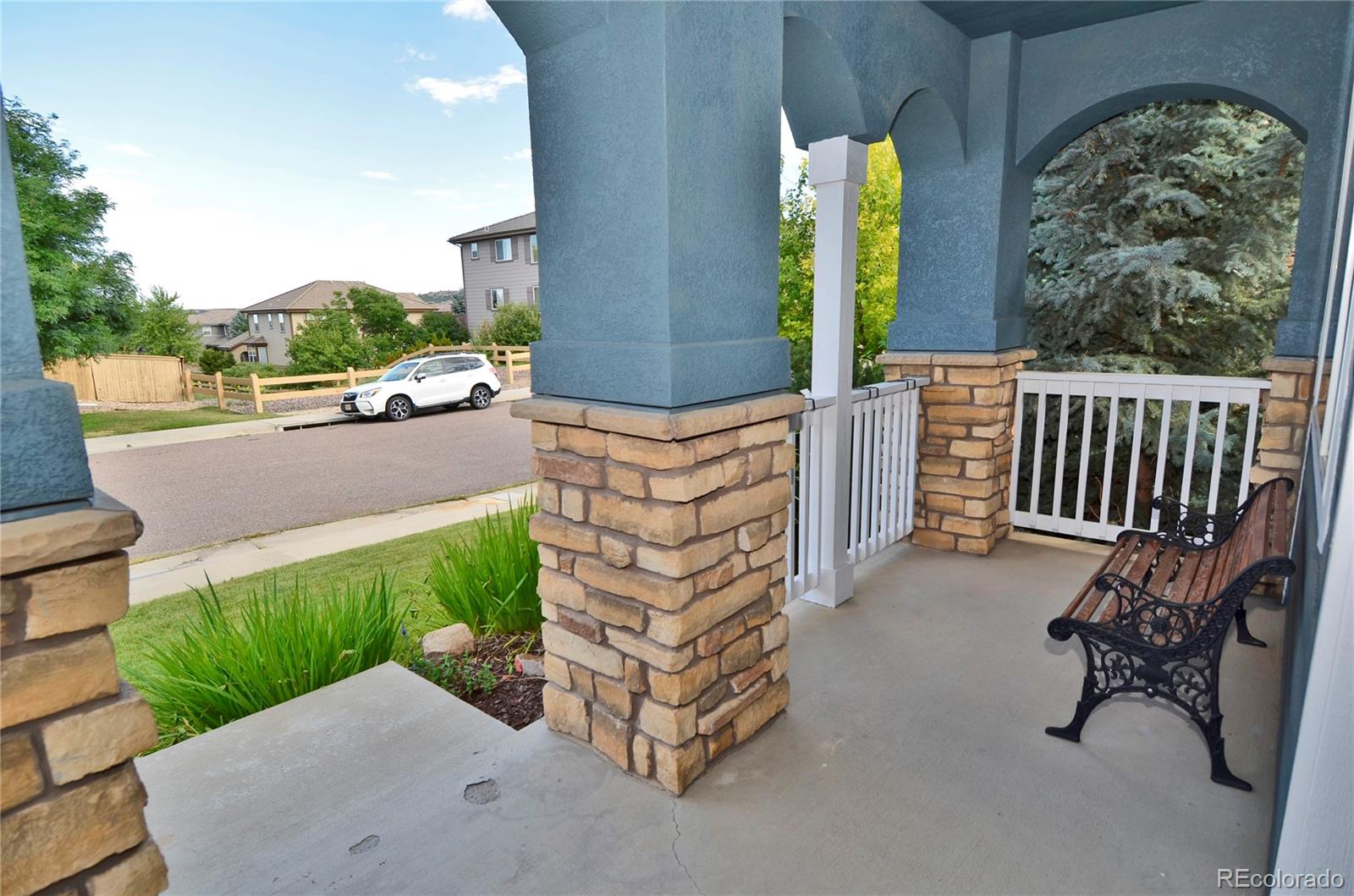 10699 Wynspire Way Highlands Ranch, CO 80130 - Photo 4 of 40 a balcony with tall trees