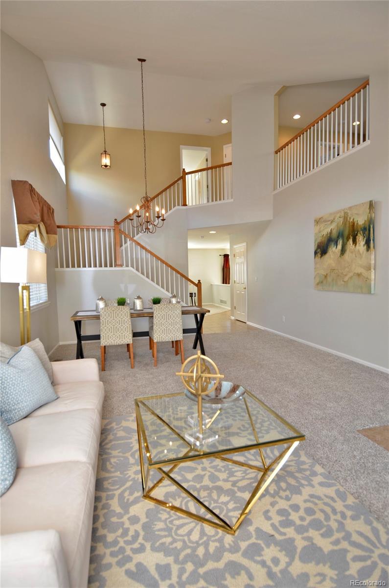 10699 Wynspire Way Highlands Ranch, CO 80130 - Photo 6 of 40 a living room with furniture and wooden floor