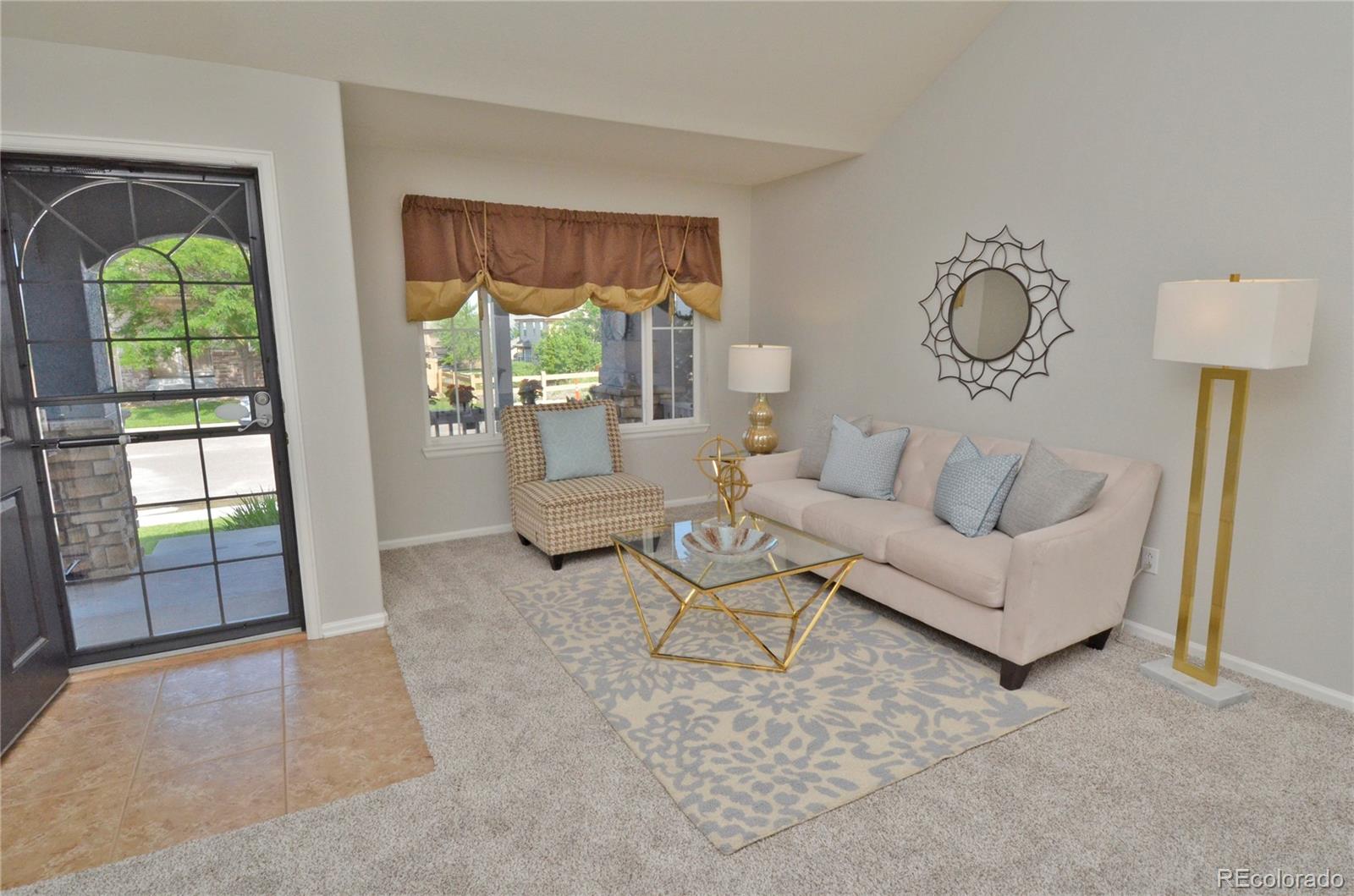 10699 Wynspire Way Highlands Ranch, CO 80130 - Photo 8 of 40 a living room with furniture and a large window