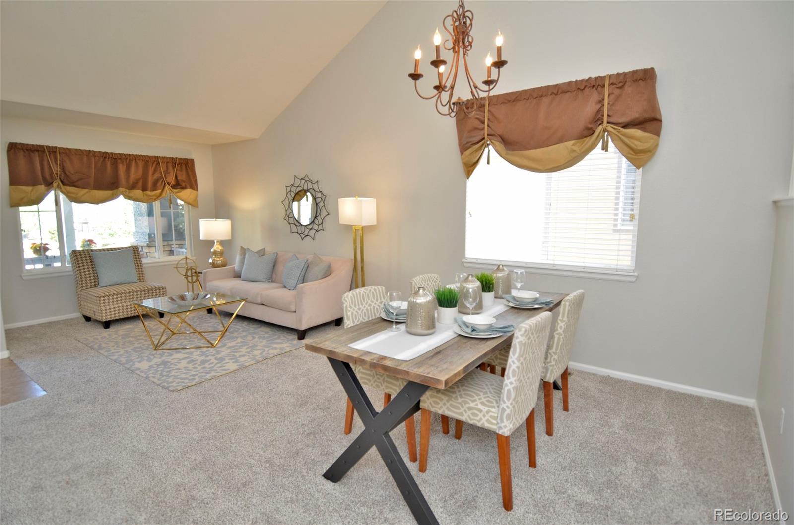10699 Wynspire Way Highlands Ranch, CO 80130 - Photo 9 of 40 a living room with furniture a window and a chandelier