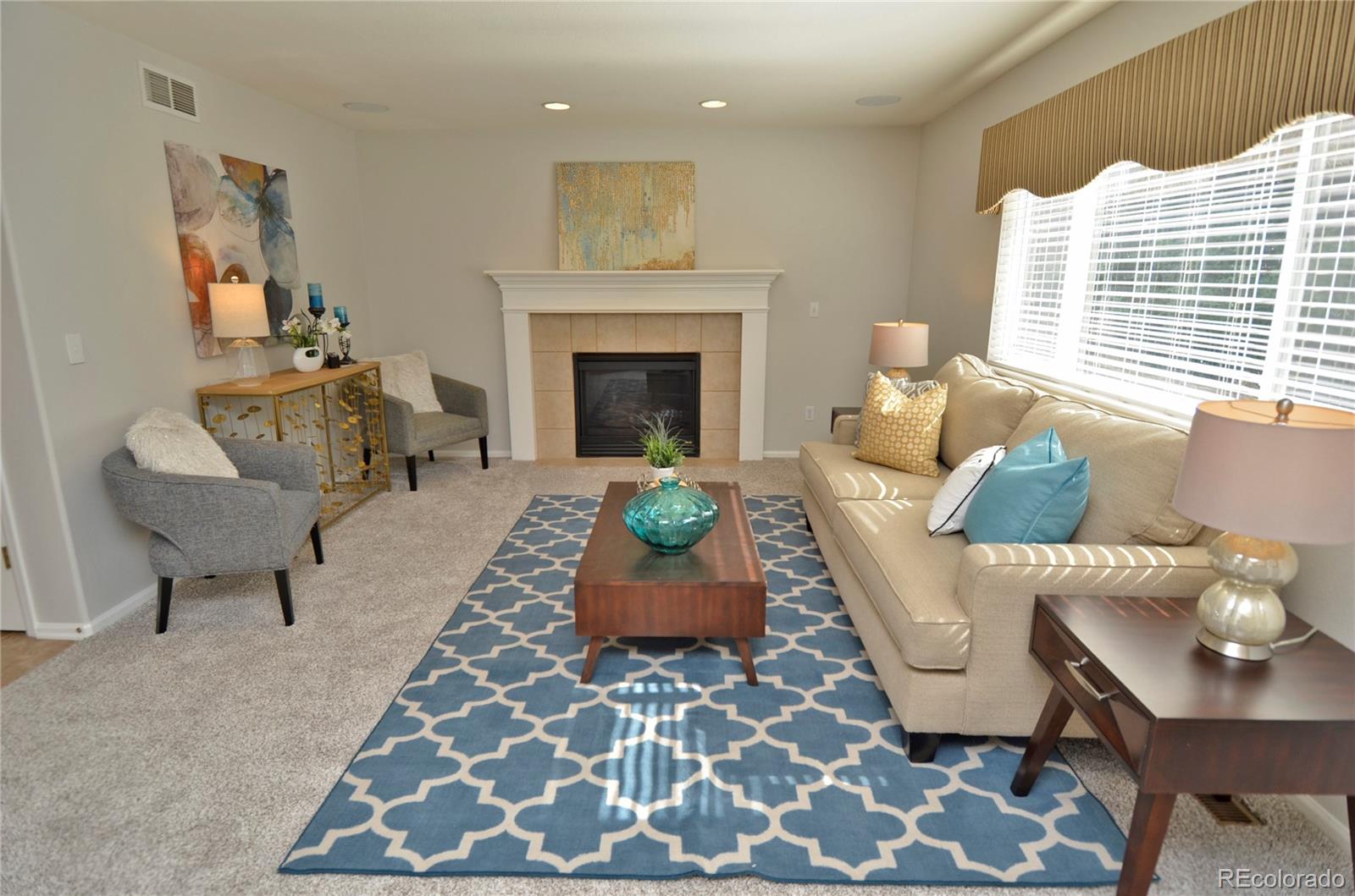 10699 Wynspire Way Highlands Ranch, CO 80130 - Photo 10 of 40 a living room with furniture and a fireplace