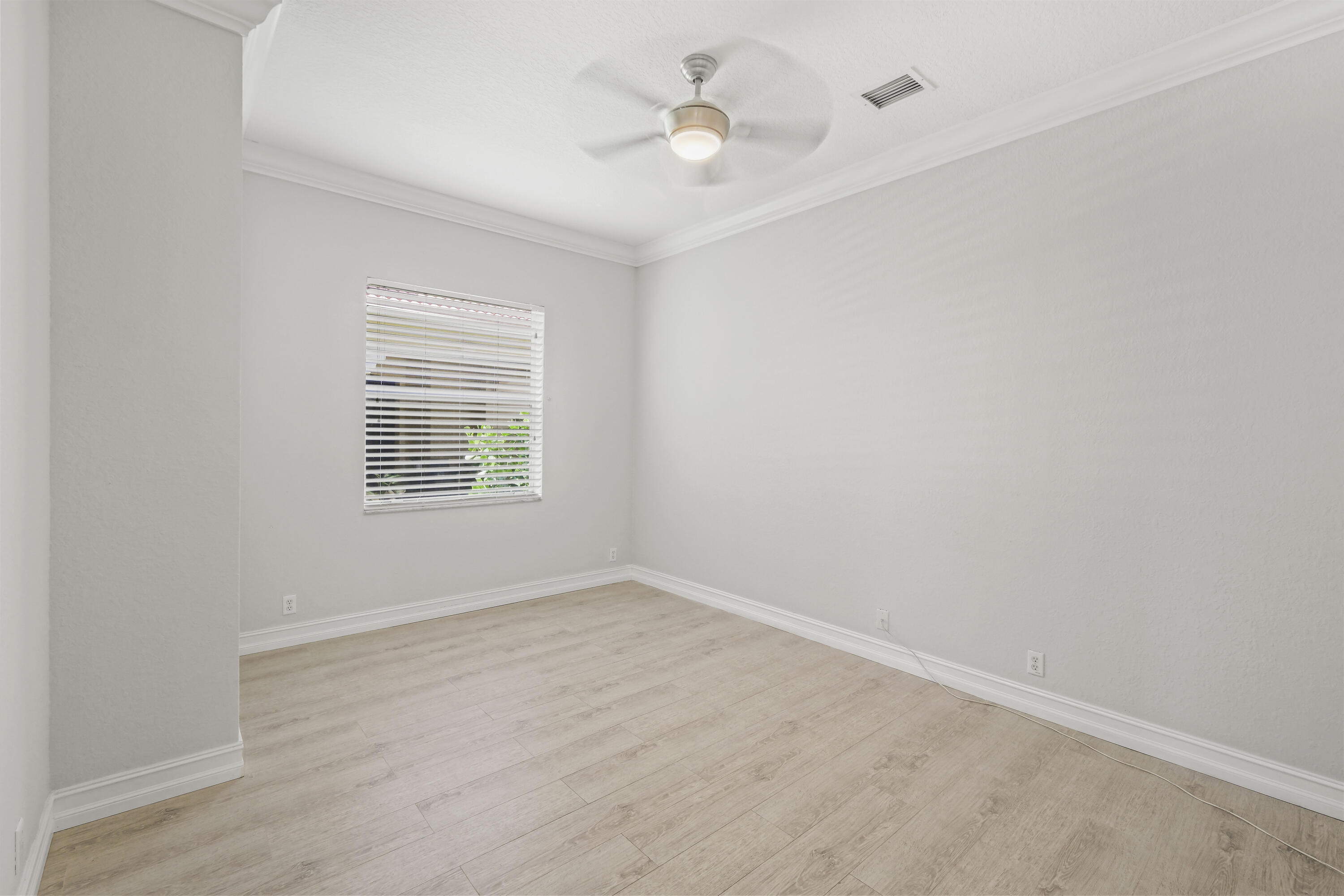 8620 Cobblestone Point Circle Boynton Beach, FL 33472 - Photo 17 of 42 an empty room with a window and ceiling fan