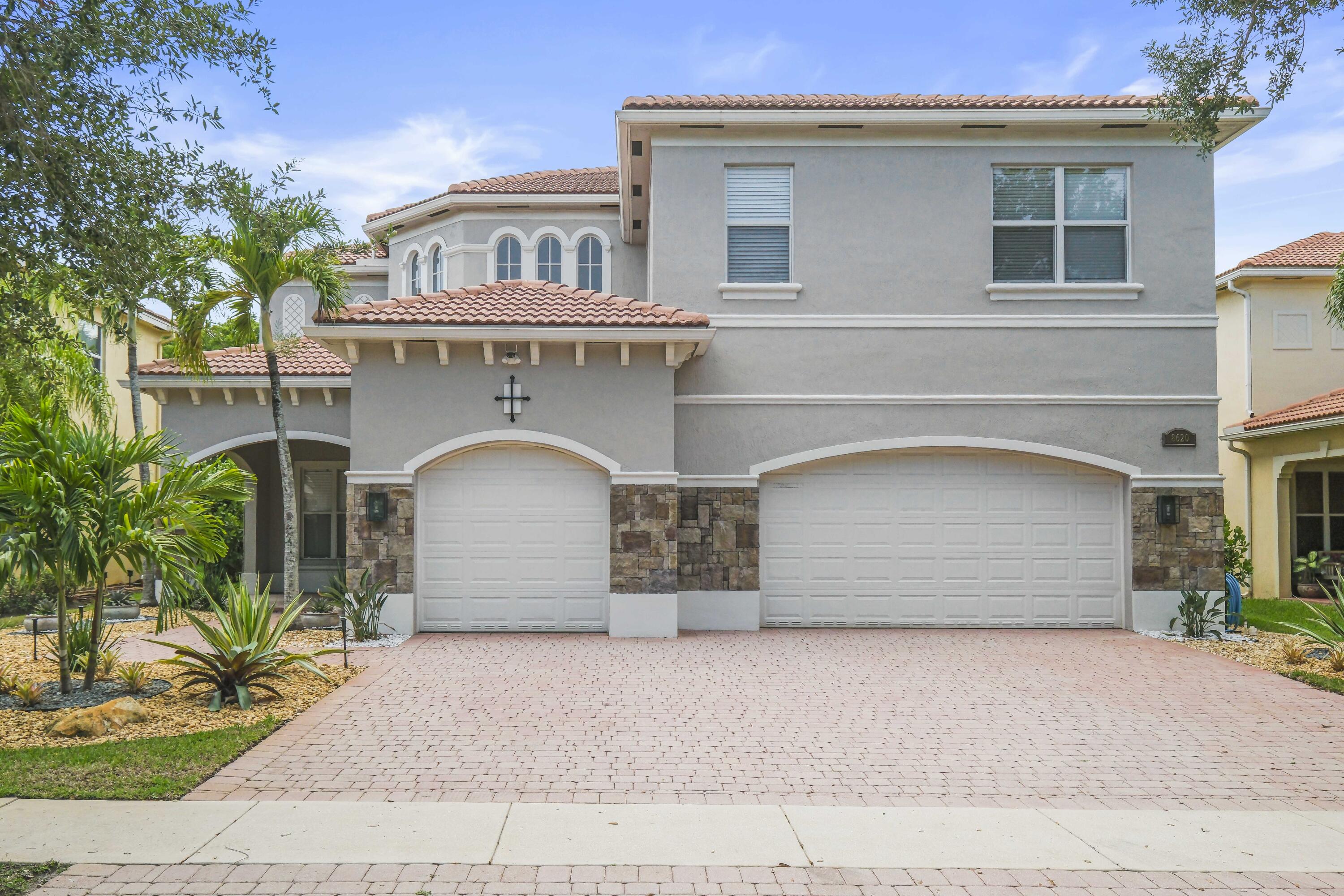8620 Cobblestone Point Circle Boynton Beach, FL 33472 - Photo 2 of 42 a front view of a house with a yard and garage