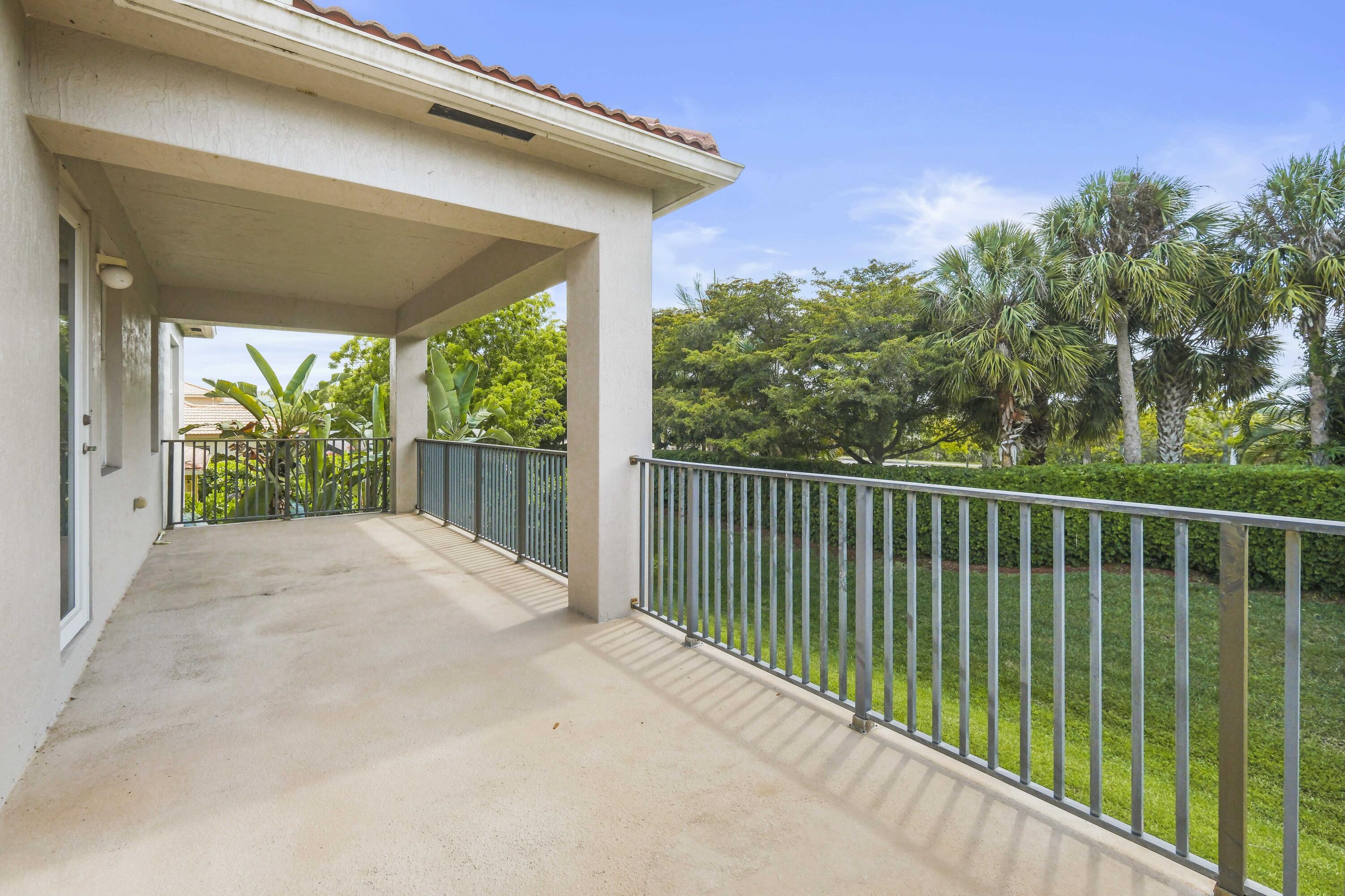 8620 Cobblestone Point Circle Boynton Beach, FL 33472 - Photo 26 of 42 a balcony with trees in front of it