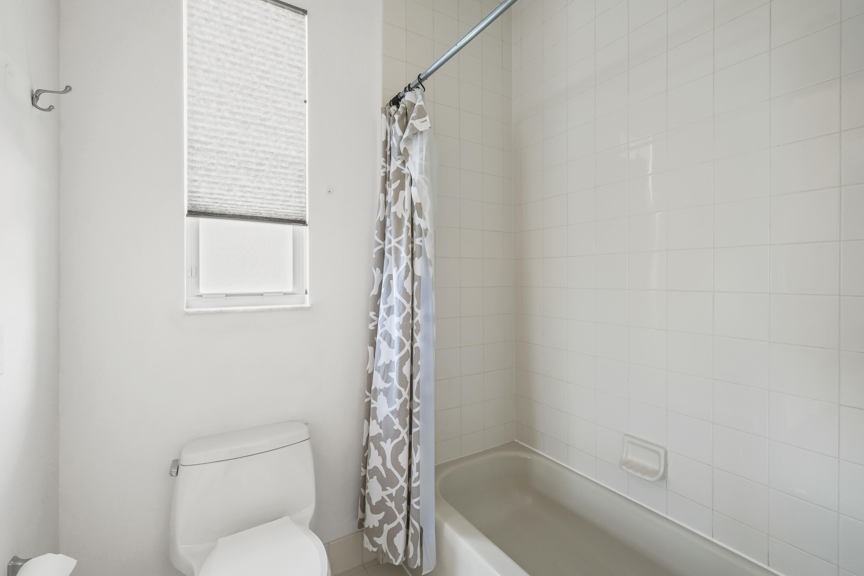 8620 Cobblestone Point Circle Boynton Beach, FL 33472 - Photo 30 of 42 a bathroom with a toilet and a shower curtain