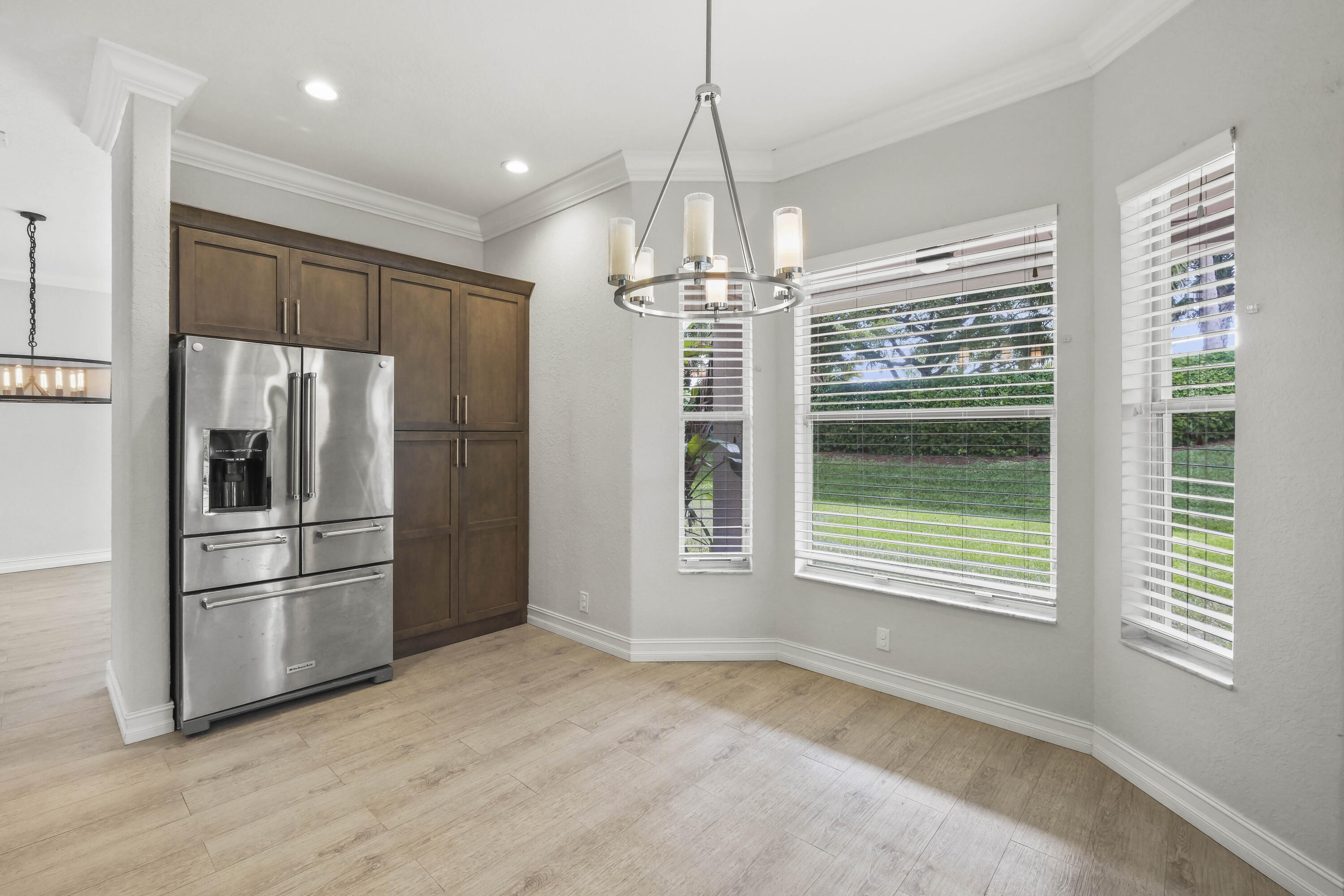 8620 Cobblestone Point Circle Boynton Beach, FL 33472 - Photo 6 of 42 a kitchen with stainless steel appliances a refrigerator and a chandelier