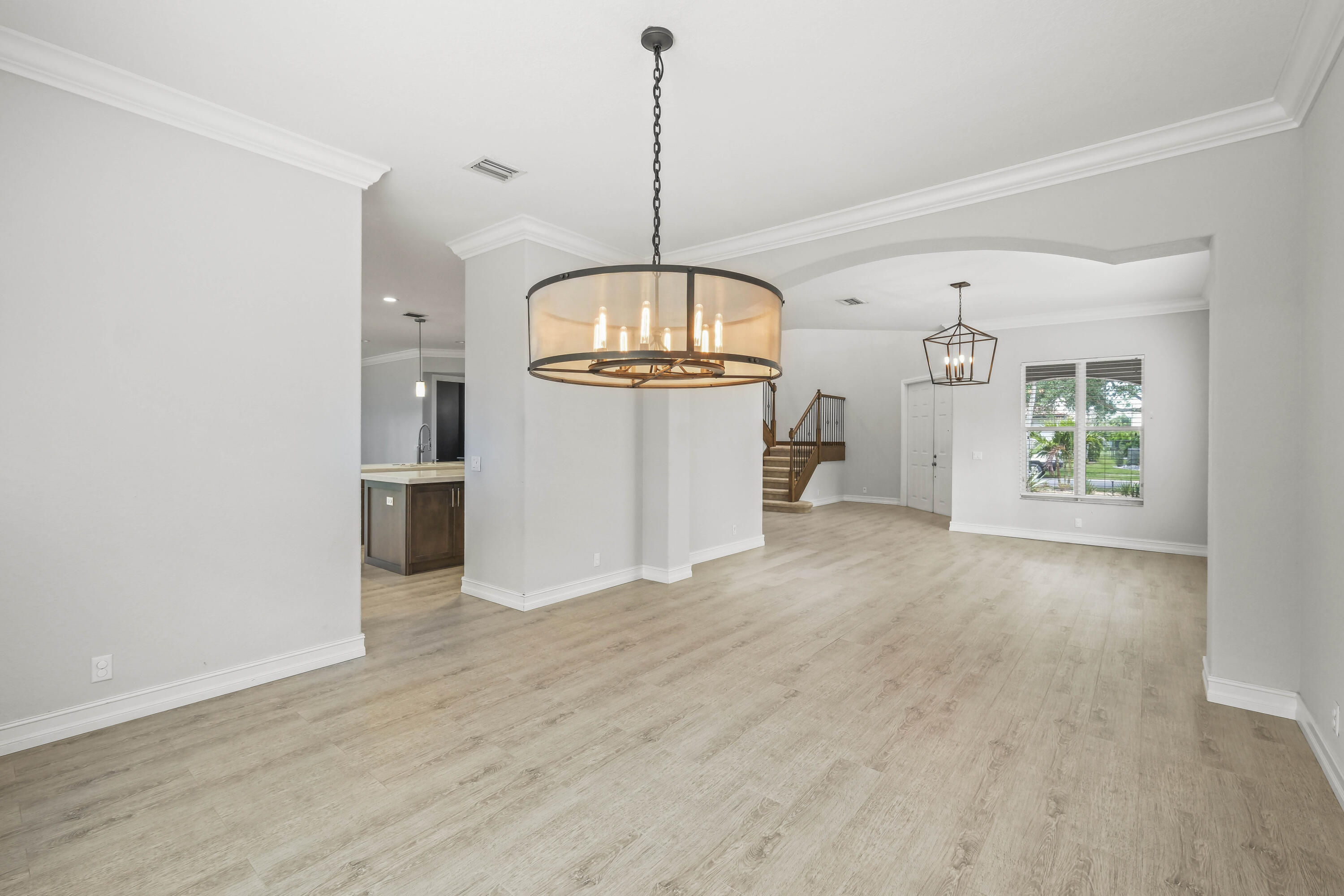 8620 Cobblestone Point Circle Boynton Beach, FL 33472 - Photo 7 of 42 a view of an empty room with a window and wooden floor