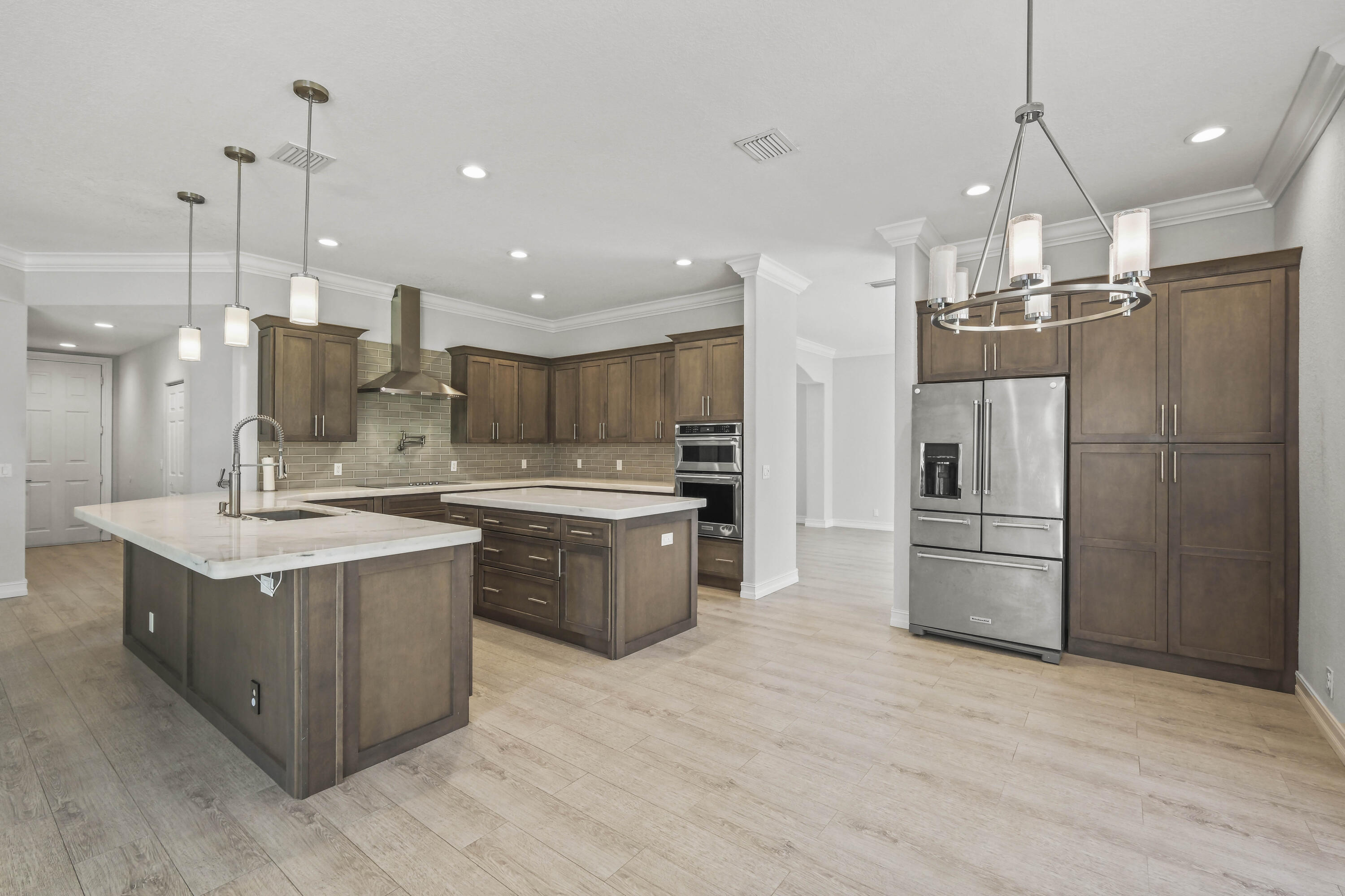 8620 Cobblestone Point Circle Boynton Beach, FL 33472 - Photo 8 of 42 a kitchen with kitchen island a sink stainless steel appliances and cabinets