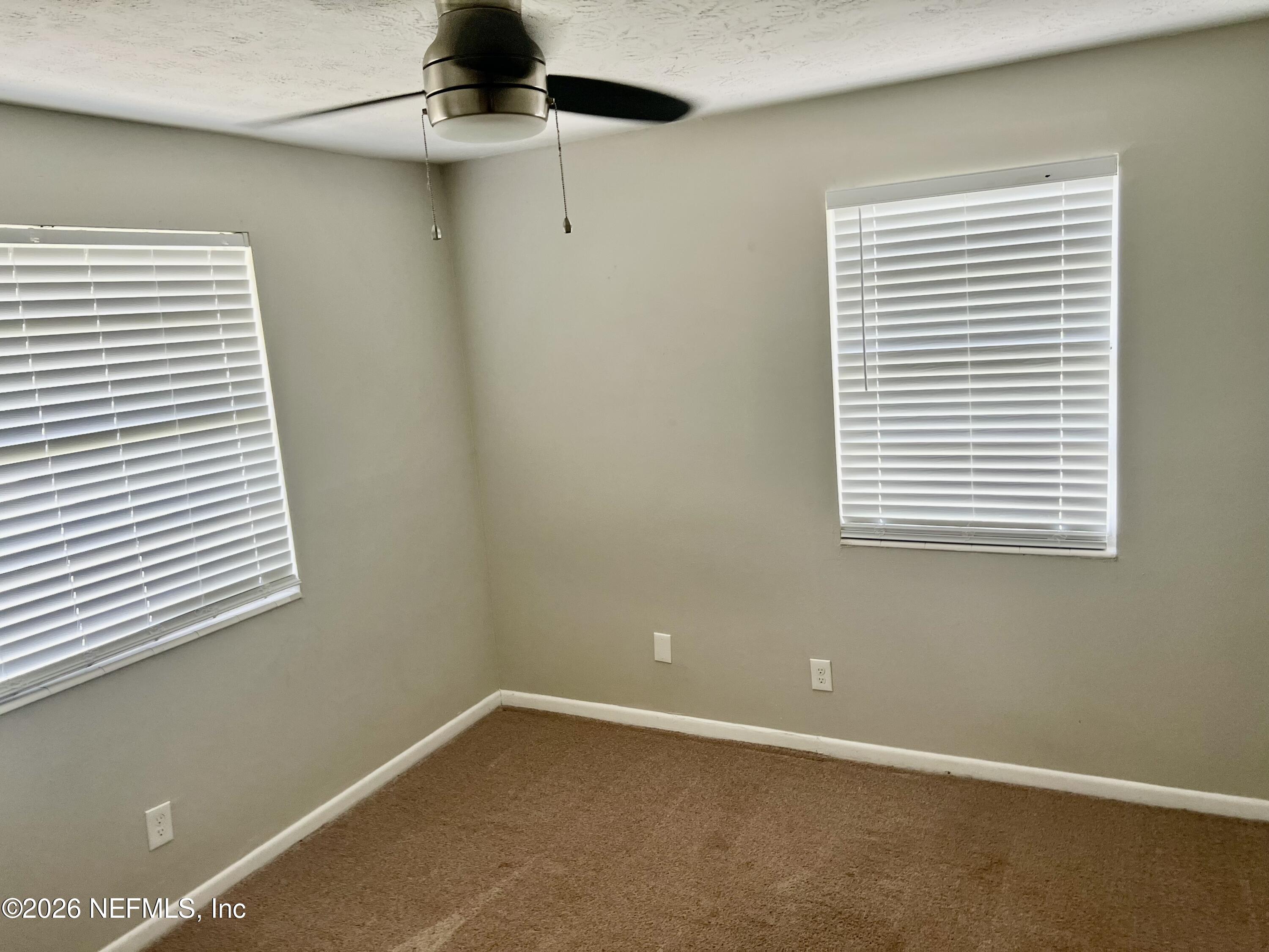 10964 Bacall Road West Jacksonville, FL 32218 - Photo 13 of 19 a view of an empty room with a window