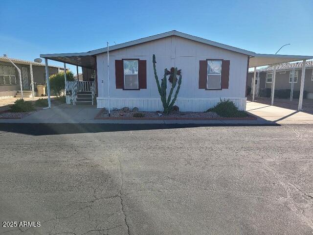 301 South Signal Butte Road, Unit 3 Apache Junction, AZ 85120 - Photo 1 of 34 a front view of a house with yard