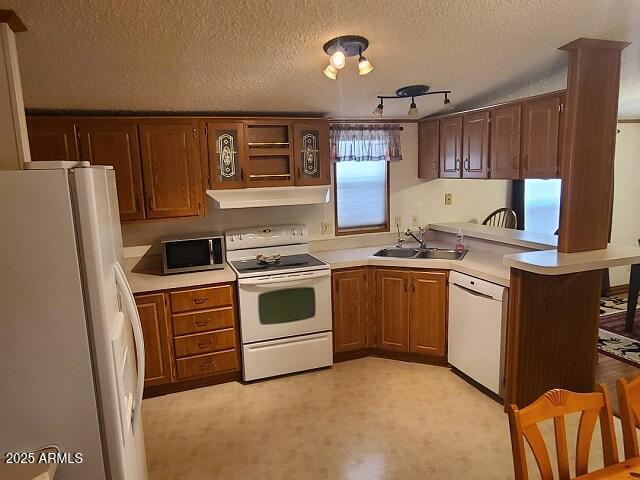 301 South Signal Butte Road, Unit 3 Apache Junction, AZ 85120 - Photo 11 of 34 a kitchen with a stove sink and refrigerator