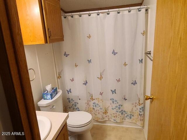 301 South Signal Butte Road, Unit 3 Apache Junction, AZ 85120 - Photo 23 of 34 a bathroom with a sink a toilet and shower curtain