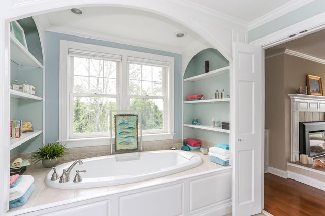 a white bath tub sitting next to a window