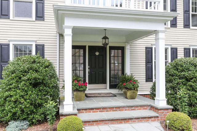 a view of a house with potted plants