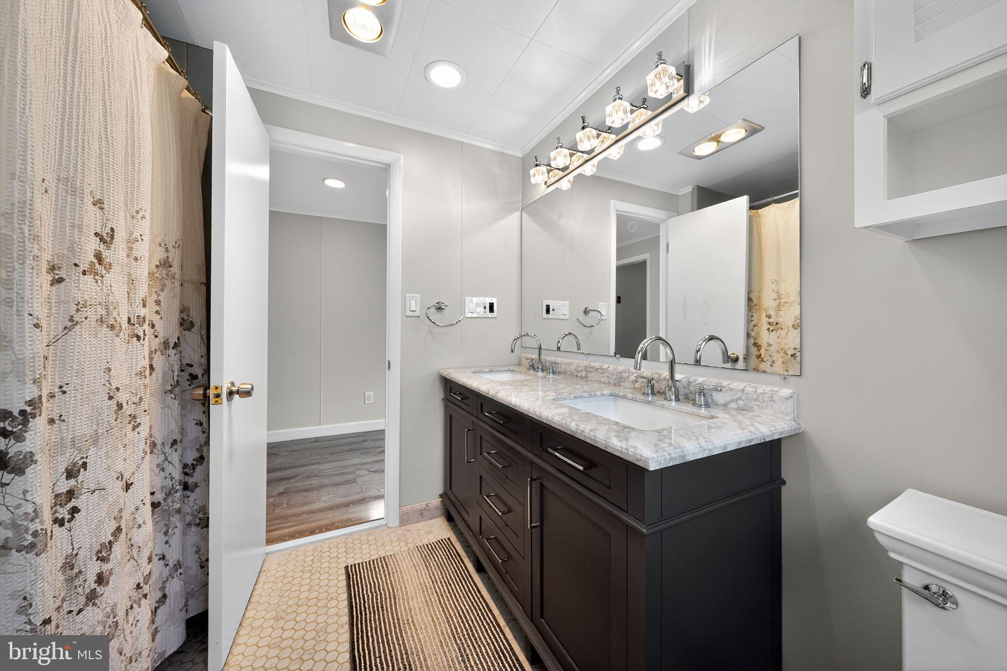 7523 B Street Chesapeake Beach, MD 20732 - Photo 11 of 29 a bathroom with a sink and a mirror