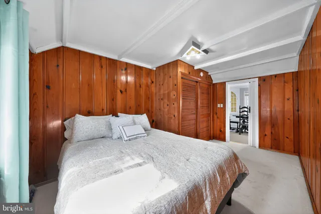 a bedroom with a large bed and a large closet