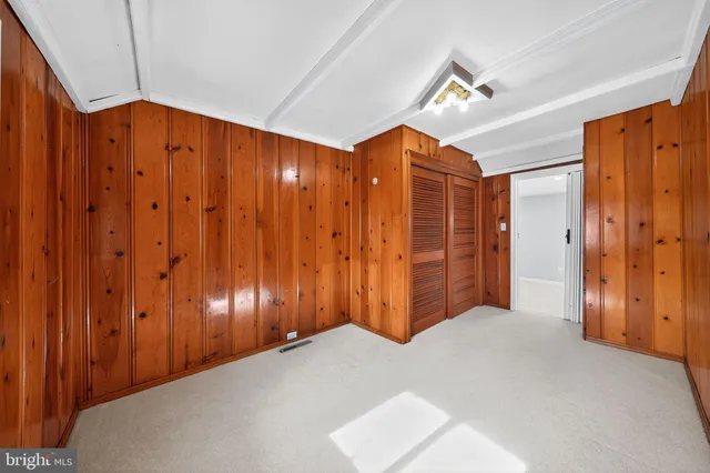 a view of an empty room with wooden walls