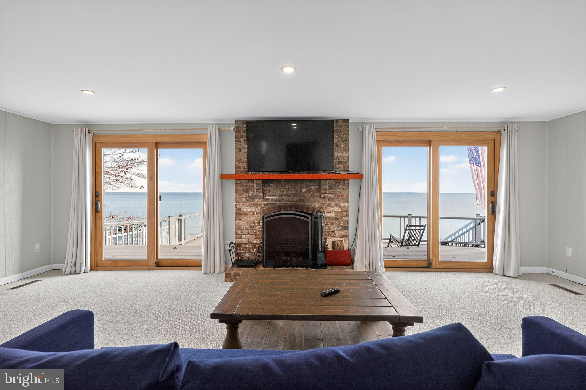 7523 B Street Chesapeake Beach, MD 20732 - Photo 17 of 29 a living room with furniture and a fireplace
